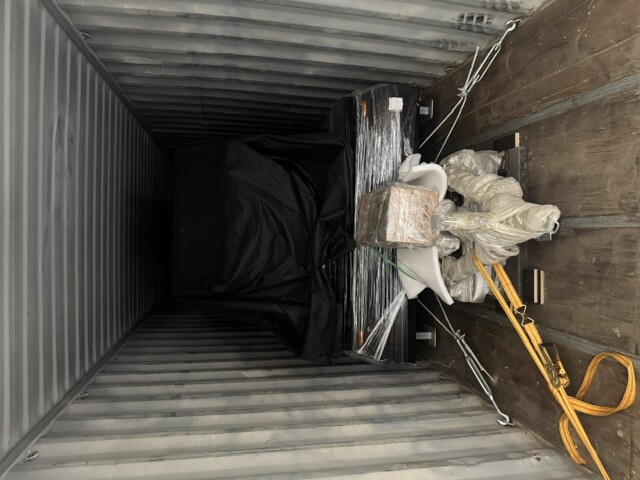 Freight being unloaded from a container trailer